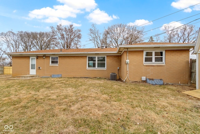 305 Bixler Rd, Indianapolis, IN 46227 - back of property featuring a yard, cooling unit, brick siding, and fence
