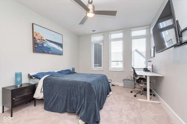 bedroom with baseboards, a ceiling fan, visible vents, and light colored carpet