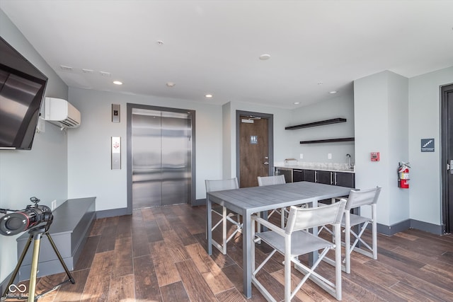 dining space with a wall unit AC, recessed lighting, baseboards, dark wood finished floors, and elevator