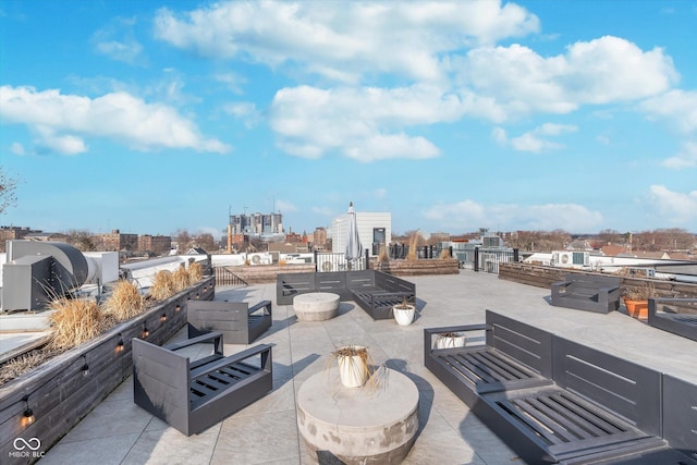 view of patio / terrace with an outdoor living space and a city view