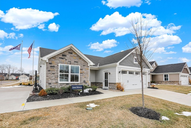 view of front of home featuring a garage, concrete driveway, a front lawn, and stone siding