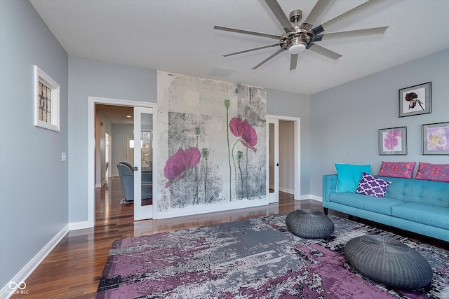 living area featuring ceiling fan, wood finished floors, and baseboards