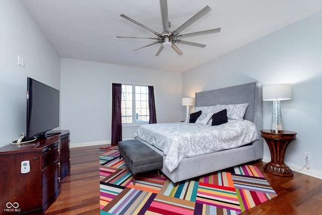 bedroom featuring a ceiling fan, dark wood-style flooring, and baseboards