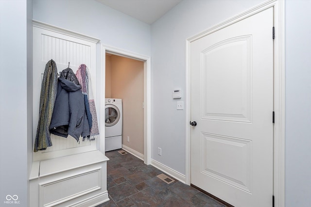 mudroom with washer / clothes dryer, stone finish floor, visible vents, and baseboards