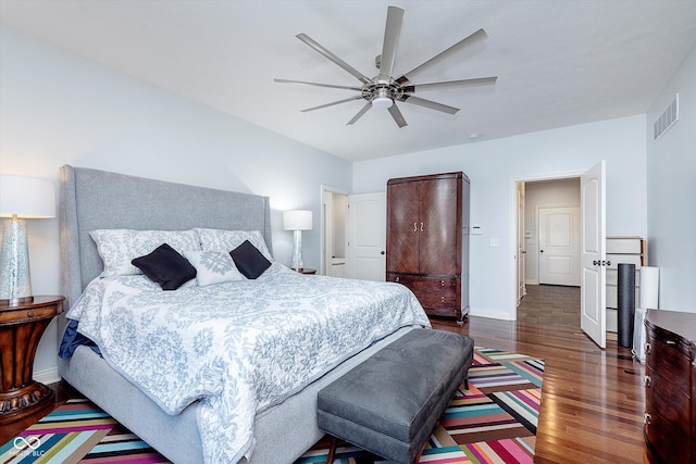 bedroom with visible vents, ceiling fan, baseboards, and wood finished floors