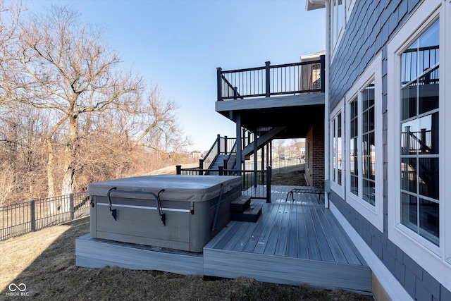 wooden deck with stairs, fence, and a hot tub