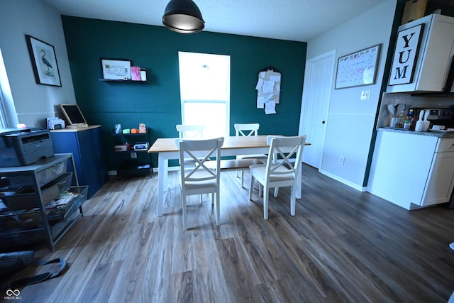 dining area featuring dark wood-style floors