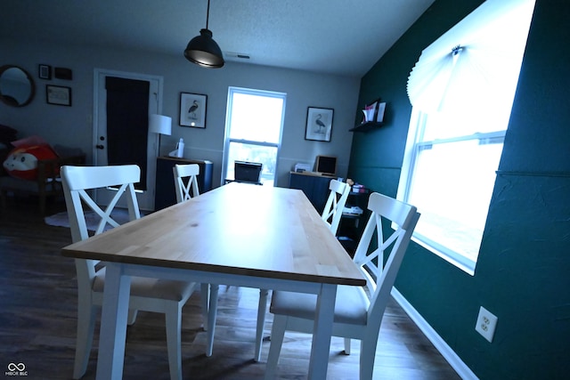 dining area featuring wood finished floors and baseboards