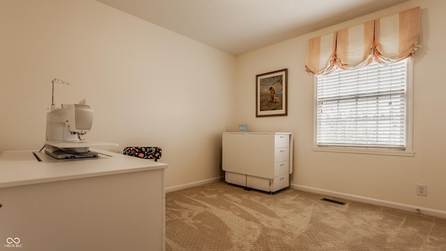 washroom featuring light carpet, visible vents, and baseboards