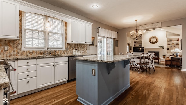 kitchen with dishwasher, dark wood-type flooring, a sink, and white cabinets