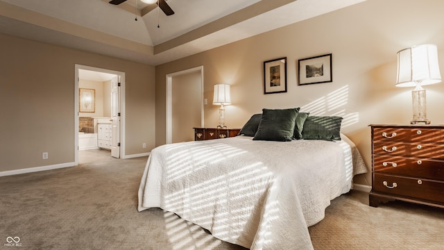 bedroom with carpet floors, connected bathroom, baseboards, and a ceiling fan