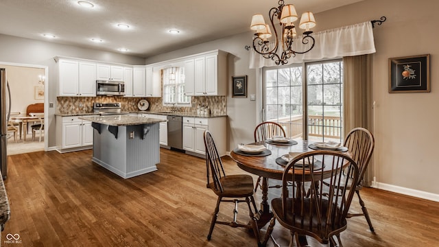 kitchen with stainless steel appliances, a sink, and white cabinetry