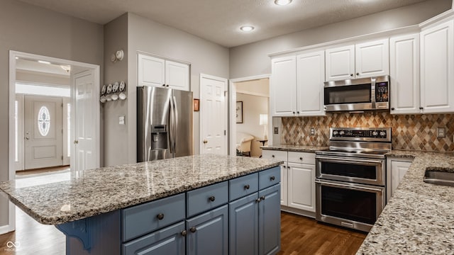 kitchen featuring appliances with stainless steel finishes and white cabinets