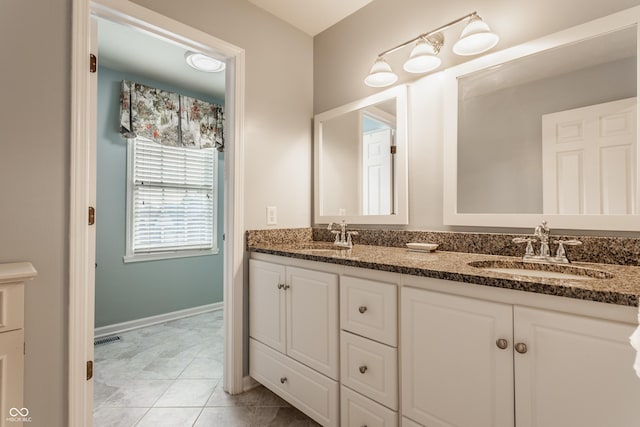 bathroom featuring tile patterned floors, visible vents, a sink, and double vanity