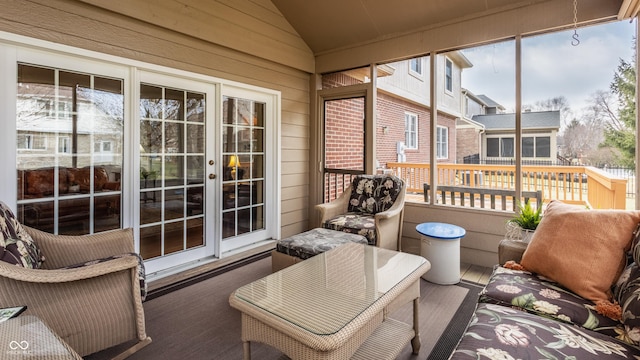 sunroom featuring vaulted ceiling