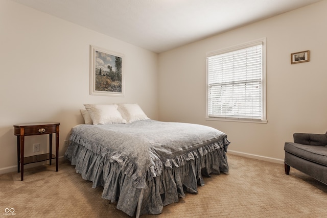 bedroom with carpet floors and baseboards