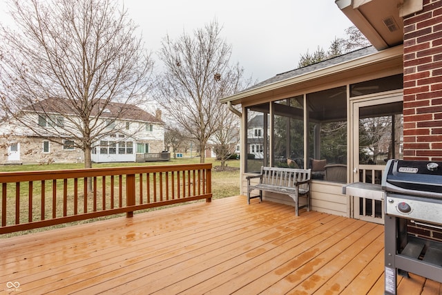 deck featuring a sunroom and grilling area