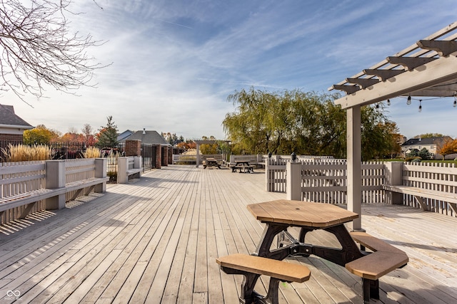 wooden deck with outdoor dining space and a pergola