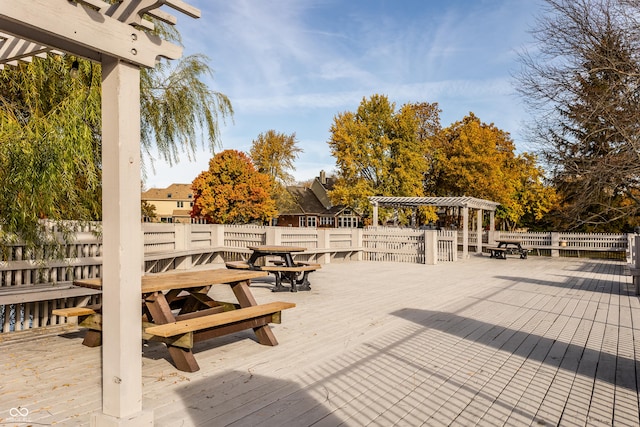 exterior space featuring fence, a deck, and a pergola