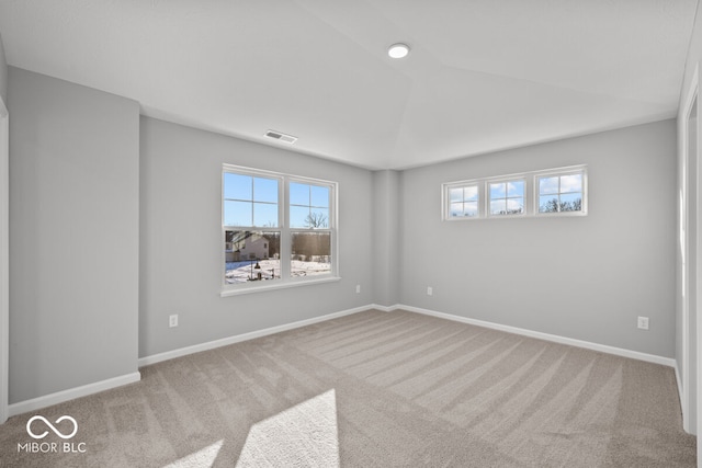 carpeted empty room featuring visible vents and baseboards