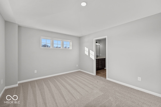 unfurnished room featuring carpet flooring and baseboards