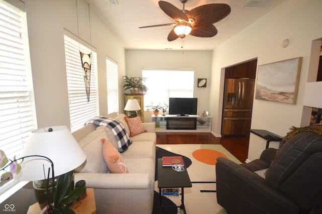 living area featuring ceiling fan, wood finished floors, and visible vents