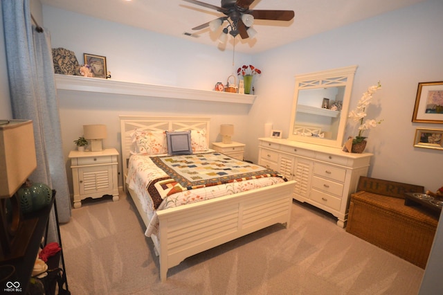 bedroom featuring light carpet, ceiling fan, and visible vents