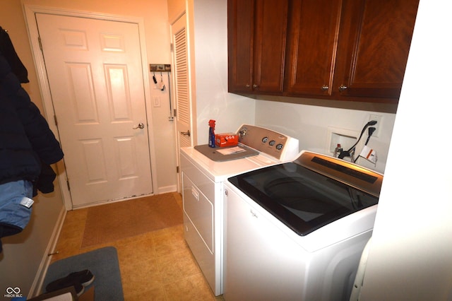 laundry room featuring light tile patterned floors, washing machine and clothes dryer, cabinet space, and baseboards