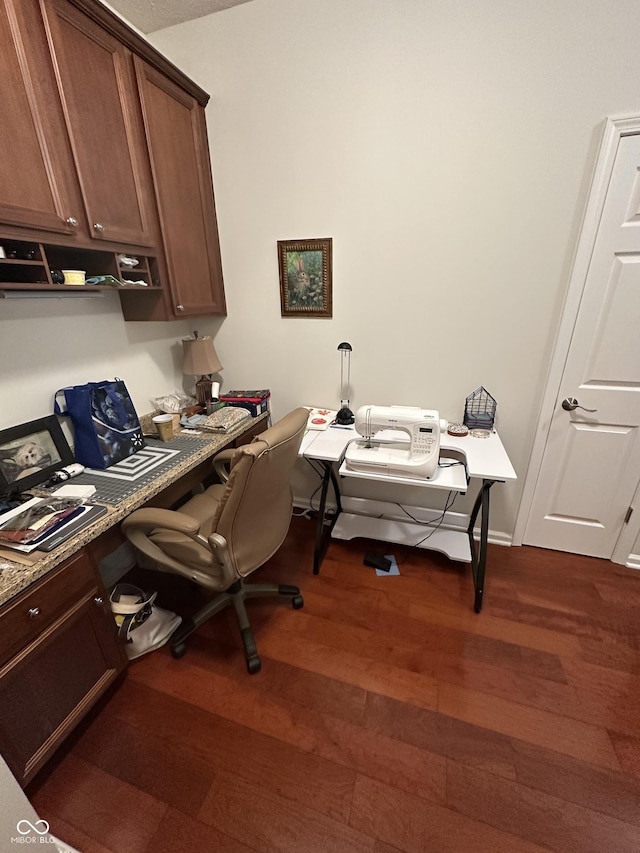 office area with dark wood-style floors and baseboards