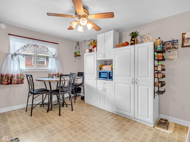 dining area with ceiling fan and baseboards