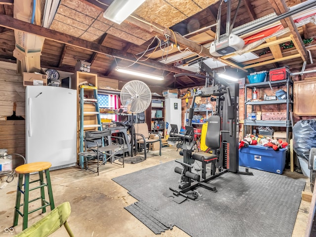 interior space with a garage and freestanding refrigerator