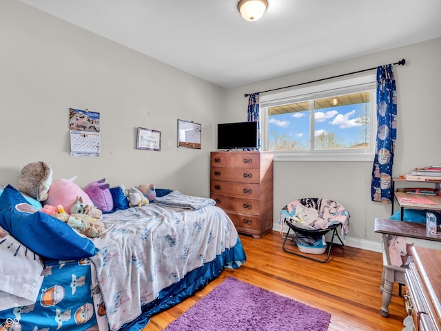 bedroom featuring baseboards and light wood-style floors