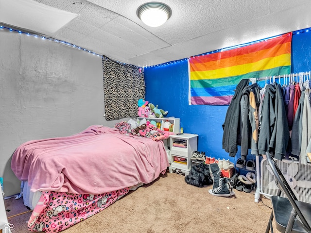 carpeted bedroom with a textured wall