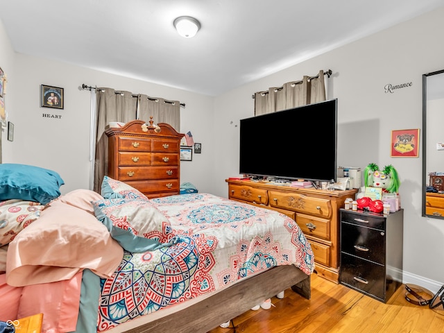 bedroom featuring light wood-type flooring and baseboards