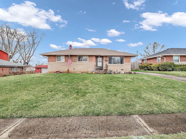 single story home with brick siding, a chimney, and a front yard