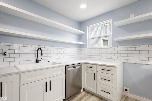 kitchen with a sink, white cabinets, open shelves, and dishwasher