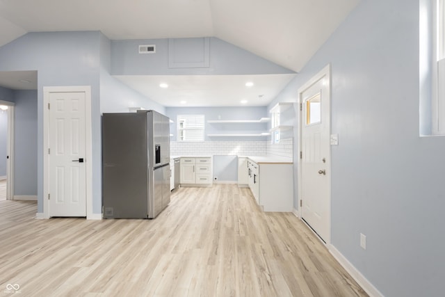 kitchen with open shelves, visible vents, stainless steel appliances, and lofted ceiling