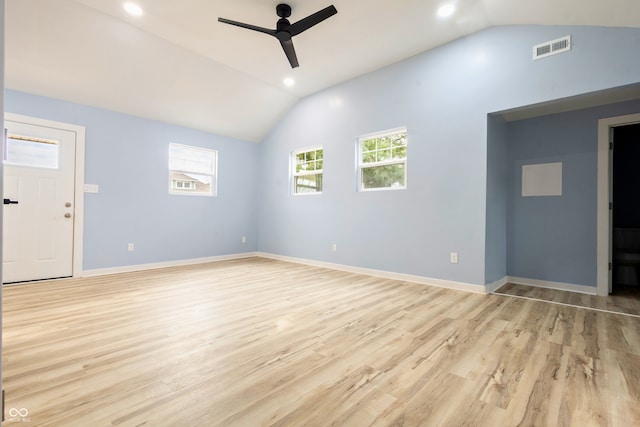 spare room featuring lofted ceiling, visible vents, ceiling fan, and light wood finished floors