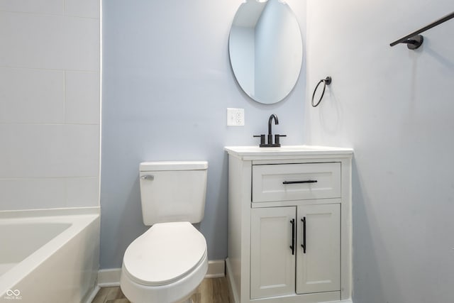 full bathroom featuring baseboards, a shower, toilet, a washtub, and vanity