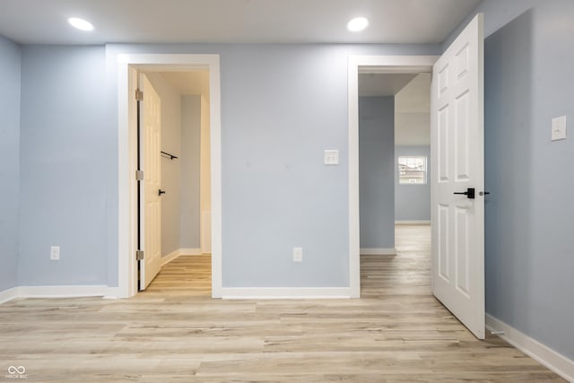 unfurnished room featuring baseboards, recessed lighting, and light wood-style floors