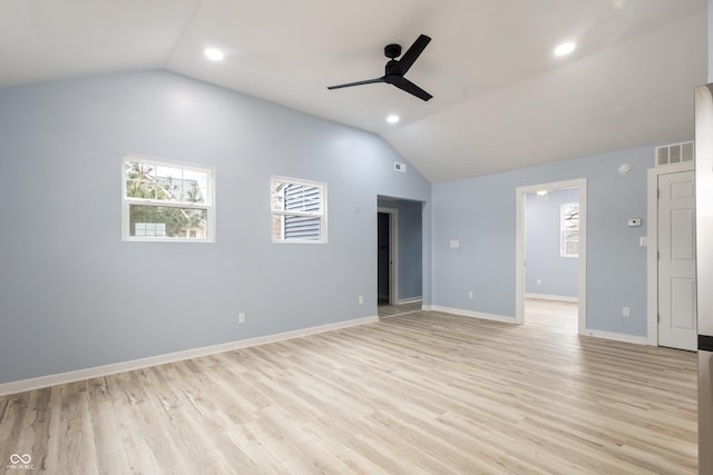 empty room with a ceiling fan, visible vents, vaulted ceiling, and light wood-style flooring