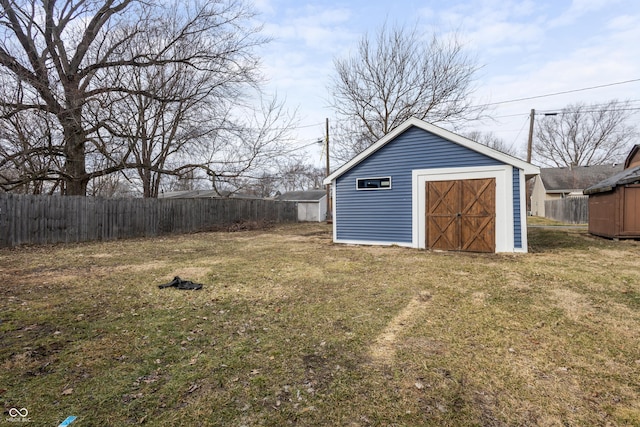 view of yard with a storage shed, an outbuilding, and fence