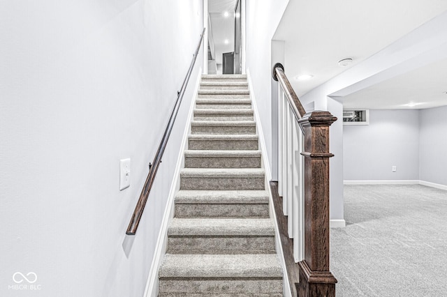 stairs featuring carpet floors and baseboards