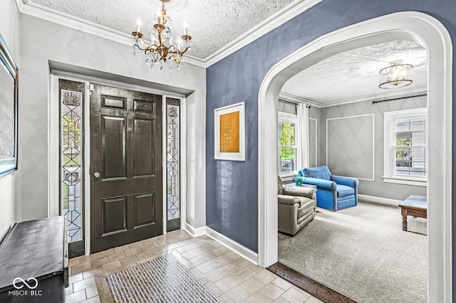 carpeted entrance foyer with an inviting chandelier, plenty of natural light, arched walkways, and crown molding