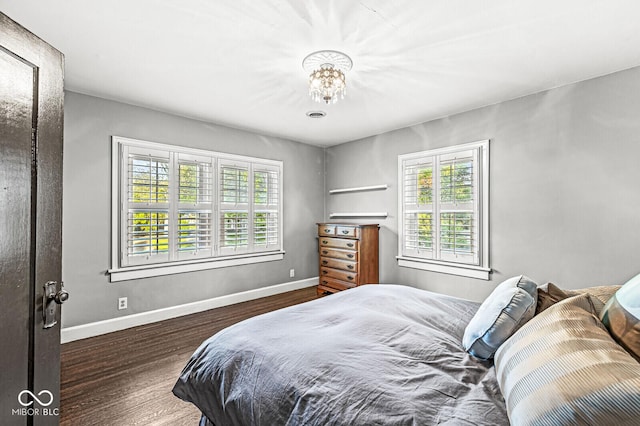 bedroom featuring baseboards and wood finished floors