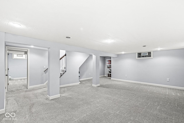 basement with stairs, baseboards, and carpet flooring