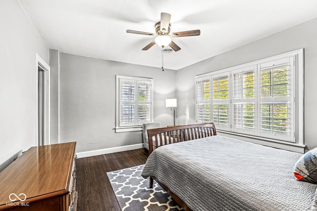 bedroom featuring dark wood-style floors, baseboards, and a ceiling fan