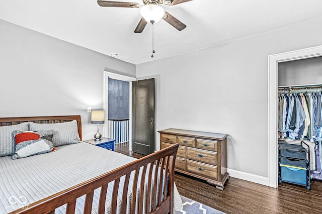 bedroom featuring a closet, wood finished floors, a ceiling fan, and baseboards