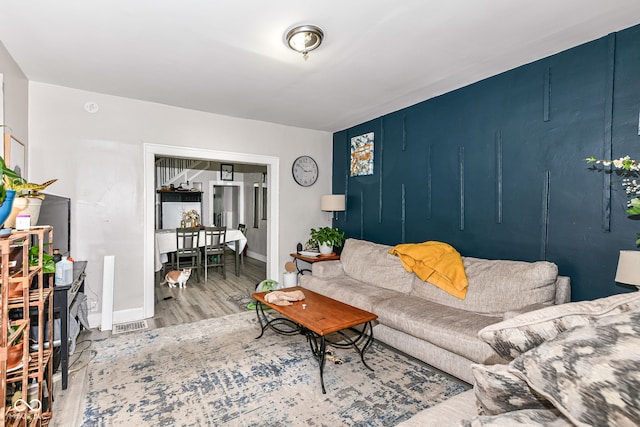 living room with baseboards and wood finished floors