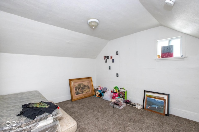 playroom with carpet and vaulted ceiling